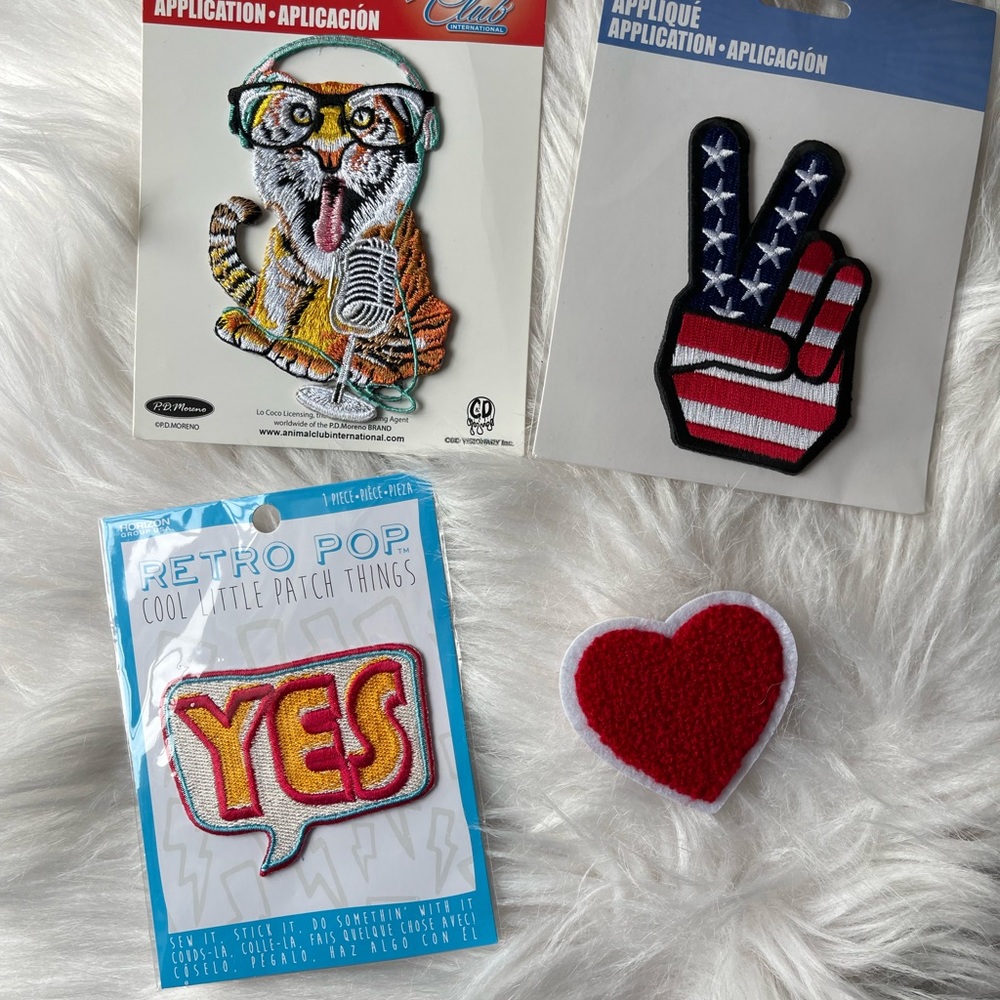 A lot of four appliqué patches. Heart, peace sign, timer, and yes!